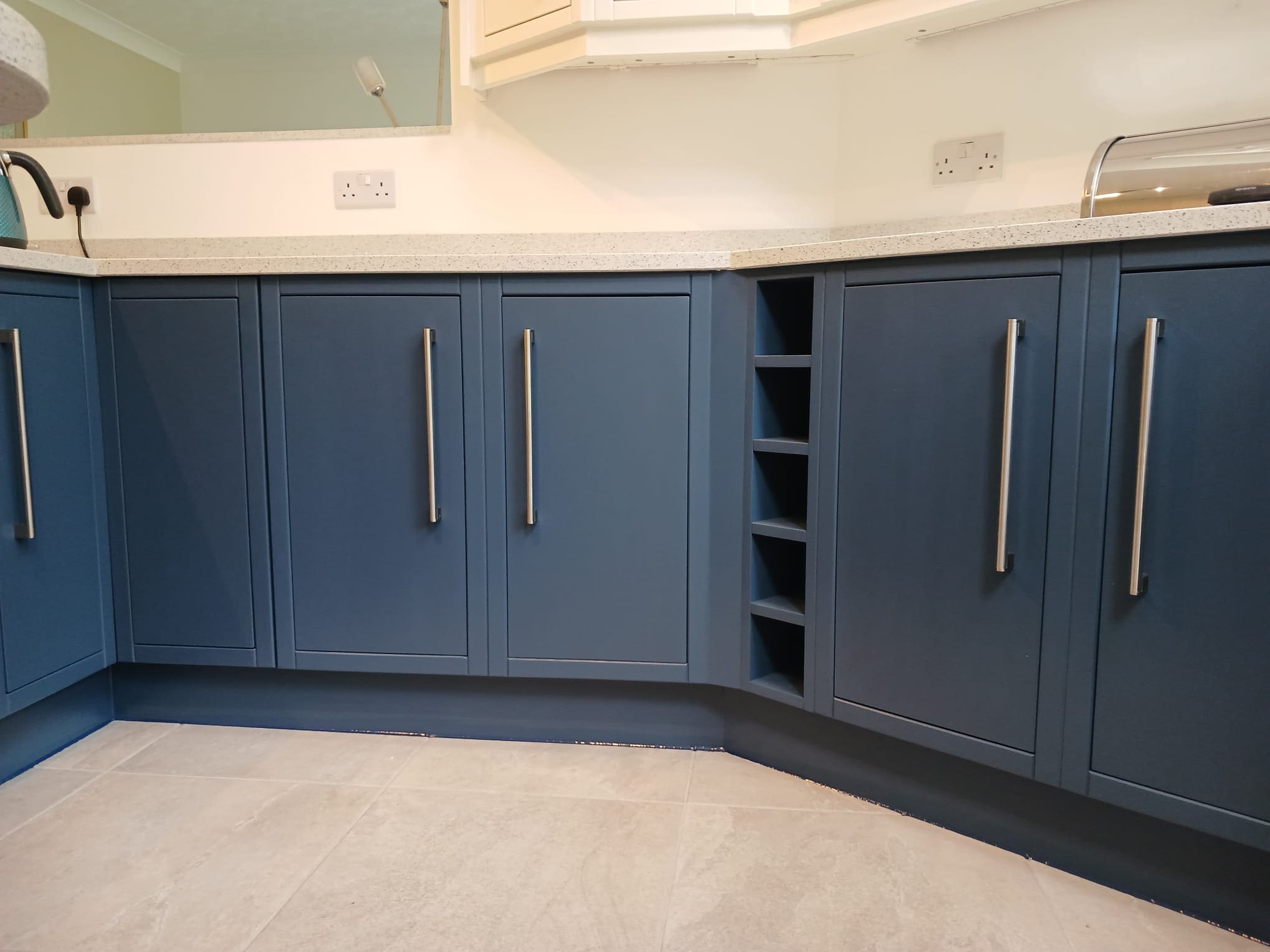 Hand painted kitchen in Leeds after painting with striking deep blue cabinets